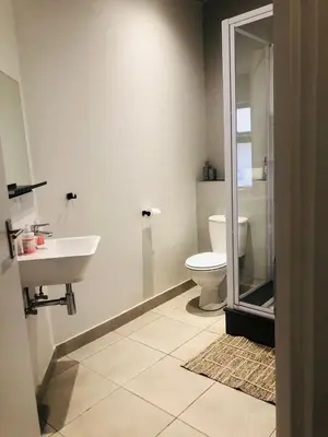 a bathroom with a toilet and a sink at Serenity stay in Kempton Park