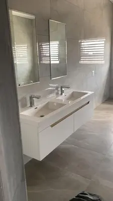 a white bathroom with two sinks and a mirror at 114 zinnia place in Midrand