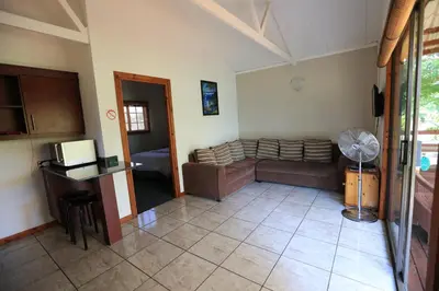 a living room with a couch and a table at Kruger View Chalets in Malelane