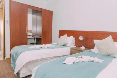 a hotel room with two beds with towels on them at Kruger View Chalets in Malelane