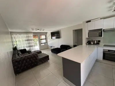 a kitchen and living room with a couch and a table at 2 Bedrooms Apartment - Hartbeespoort Dam in Hartbeespoort