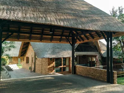 a pavilion with a thatched roof on a building at DUBE SAFARI LODGE at Kruger Park Lodge 505 in Hazyview