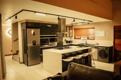 a kitchen with a large island in the middle at DUBE SAFARI LODGE at Kruger Park Lodge 505 in Hazyview