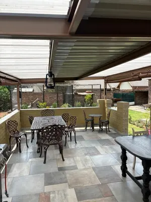 an outdoor patio with tables and chairs and a table and chairs at Lulus bistro in Middelburg