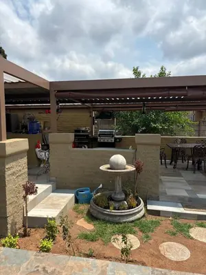 a patio with a fountain with a table and a grill at Lulus bistro in Middelburg