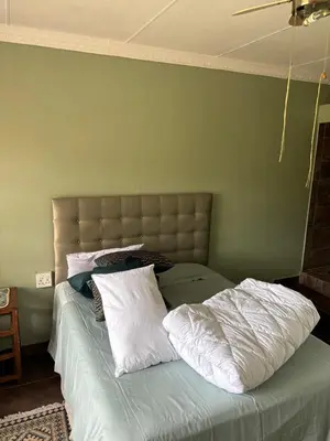 a bed with two white pillows on top of it at Lulus bistro in Middelburg