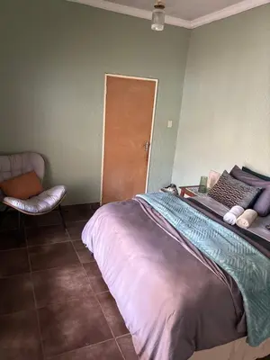 a bedroom with a bed and a chair in it at Lulus bistro in Middelburg
