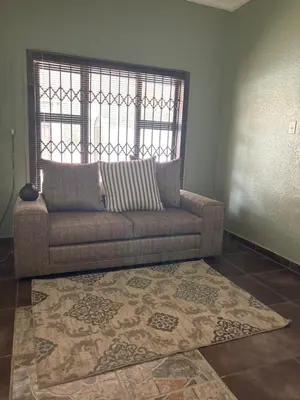 a living room with a couch and a rug at Lulus bistro in Middelburg