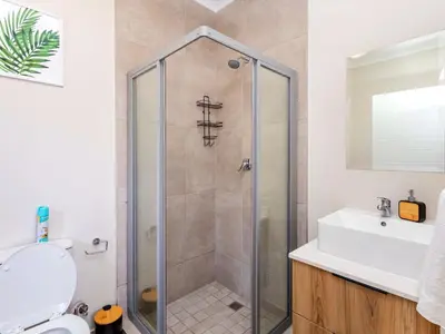 a bathroom with a shower and a sink at Glen Haven in Midrand