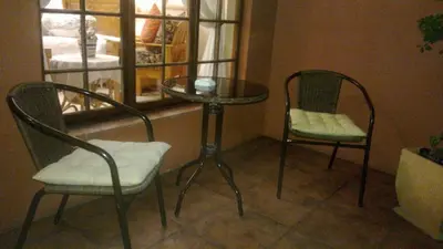 two chairs and a table and a table and two chairs at Harmony Guesthouse in Nelspruit