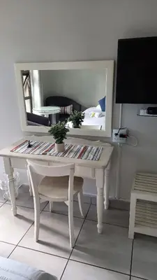 a white desk in a room with a mirror at Harmony Guesthouse in Nelspruit