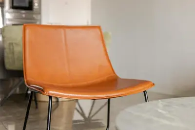 an orange chair sitting in front of a table at Jabba at Ellipse Waterfall in Midrand