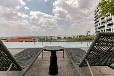 a table and two chairs in front of a pool at Jabba at Ellipse Waterfall in Midrand