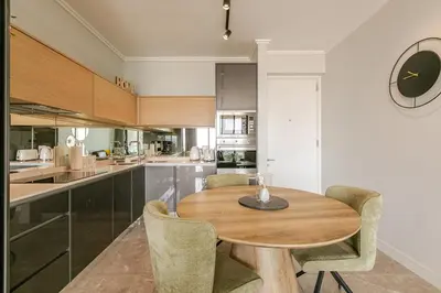 a kitchen with a wooden table and chairs at Jabba at Ellipse Waterfall in Midrand