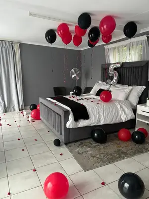 a bedroom with red and black balloons on the floor at Serene Oasis in Tierpoort