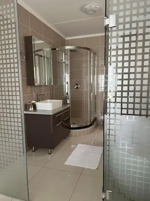 a bathroom with a sink and a shower at Micasa apartments in Midrand