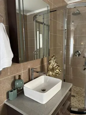 a bathroom with a white sink and a shower at Micasa apartments in Midrand
