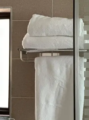a group of towels on a towel rack in a bathroom at Micasa apartments in Midrand