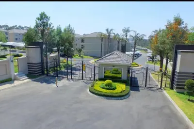 a gate with a garden in front of it at Micasa apartments in Midrand