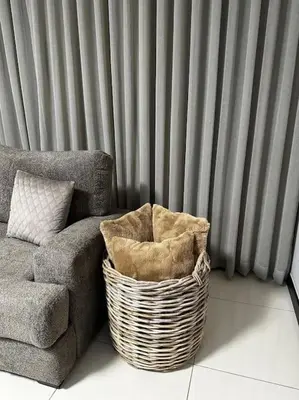 a wicker basket sitting next to a couch and a window at Micasa apartments in Midrand
