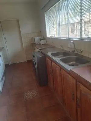 a kitchen with a sink and a dishwasher at mokede Iin in Pretoria