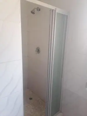 a shower with a glass door in a bathroom at mokede Iin in Pretoria