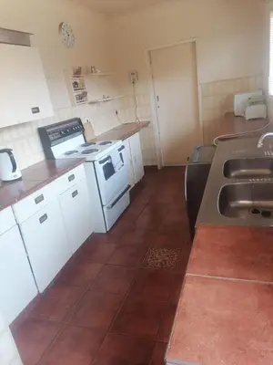 a kitchen with a sink and a stove at mokede Iin in Pretoria
