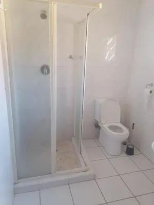 a bathroom with a shower and a toilet at mokede Iin in Pretoria