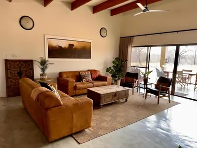 a living room with two couches and a coffee table at Mananga Bush Villa in Skukuza