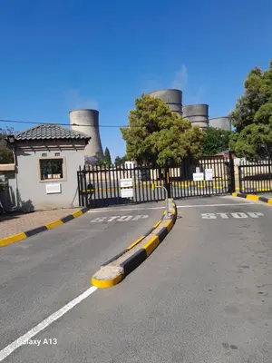 an empty road in front of a factory at White House in Kempton Park