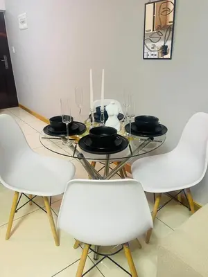 a dining room with a table with white chairs at 12th La Maison in Erand