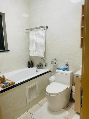 a bathroom with a toilet and a bath tub at 12th La Maison in Erand