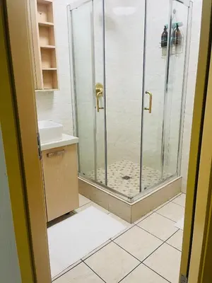 a bathroom with a shower and a sink at 12th La Maison in Erand