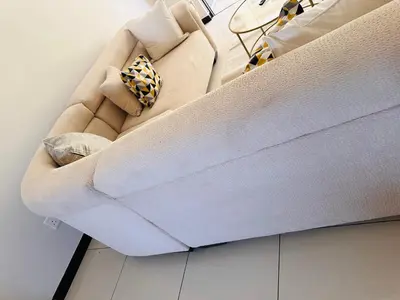 a couch sitting in a living room at Tranquility in Erand