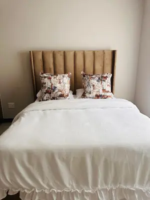 a large white bed with two pillows on it at Tranquility in Erand
