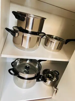 two pots and pans on a shelf in a kitchen at Tranquility in Erand