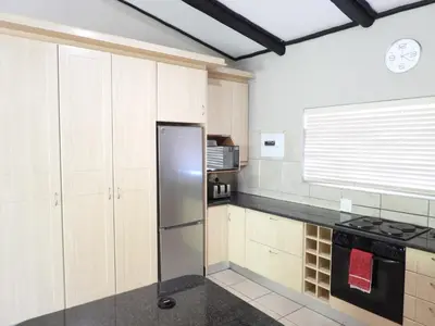 a kitchen with a stainless steel refrigerator and cabinets at DaGama Dam - White River - Kite - C11 in Swartfontein