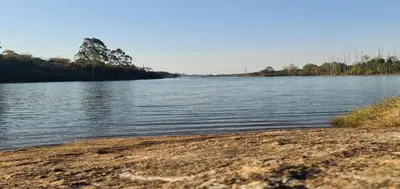 a large body of water with trees in the distance at DaGama Dam - White River - Kite - C11 in Swartfontein