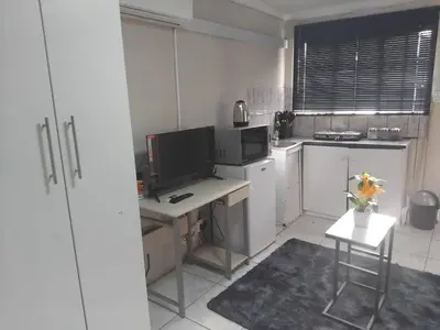 a kitchen with a desk with a computer in it at Angel Secure Unit in Pretoria