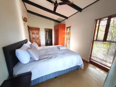 a bedroom with a large bed with white pillows at DaGama Dam - White River - Martial Eagle - C23 in Swartfontein