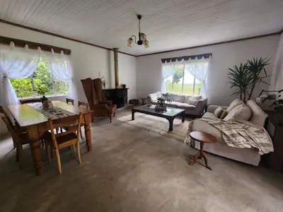 a living room with a couch and a table at Country Cottage in Koppie Alleen