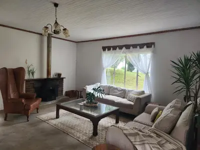 a living room with a couch and a coffee table at Country Cottage in Koppie Alleen