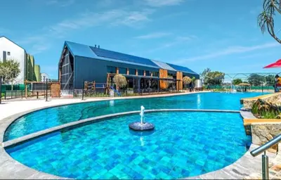 a large blue swimming pool in front of a building at Chaka at TheCreek in Pretoria