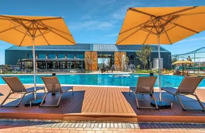two chairs and two umbrellas next to a swimming pool at Chaka at TheCreek in Pretoria