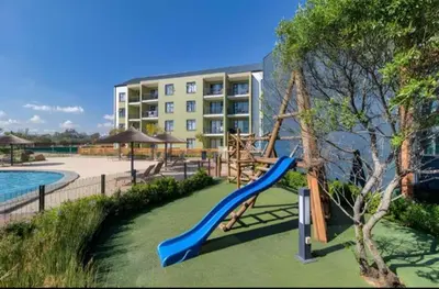 a playground with a slide in front of a building at Chaka at TheCreek in Pretoria