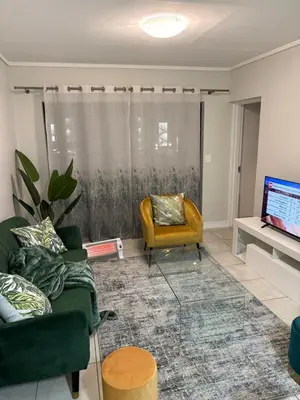 a living room with a couch and a chair at Chaka at TheCreek in Pretoria