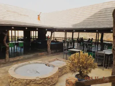 a patio with a fountain and tables and chairs at Mabalingwe Nature Reserve - Elephant Lodge - Tjaila in Bela-Bela