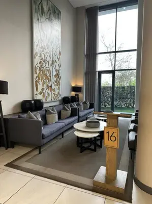 a living room with a couch and a table at Menlyn Maine Golden Sands in Pretoria