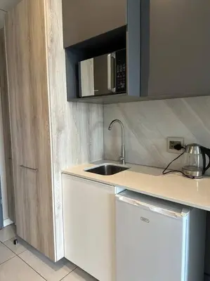 a kitchen with a sink and a microwave at Menlyn Maine Golden Sands in Pretoria