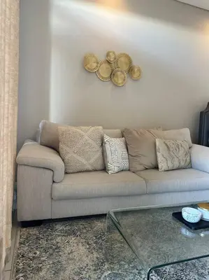 a living room with a couch and a table at Menlyn Maine Golden Sands in Pretoria